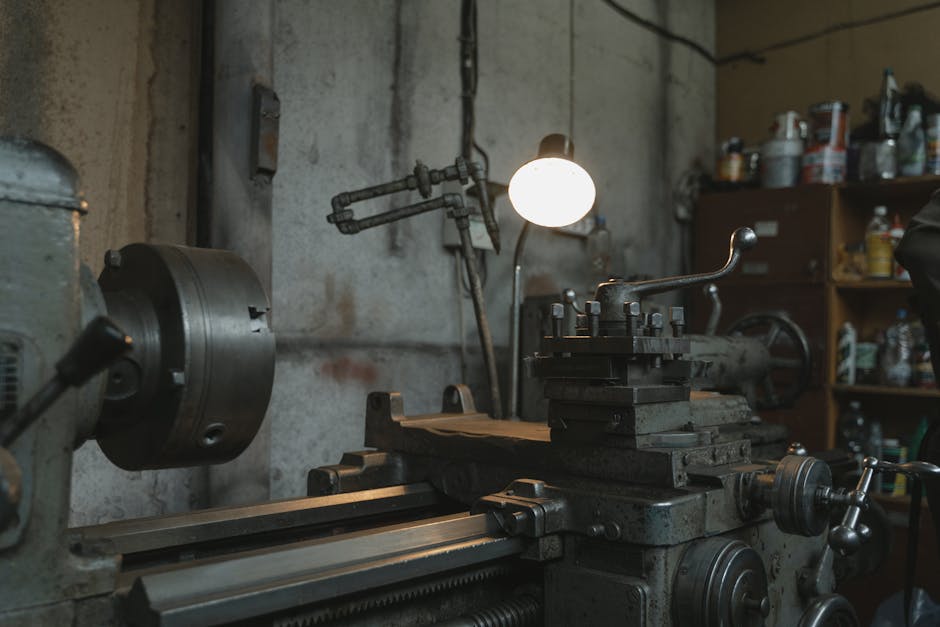 An atmospheric shot of an industrial workshop featuring a lathe machine and various tools.